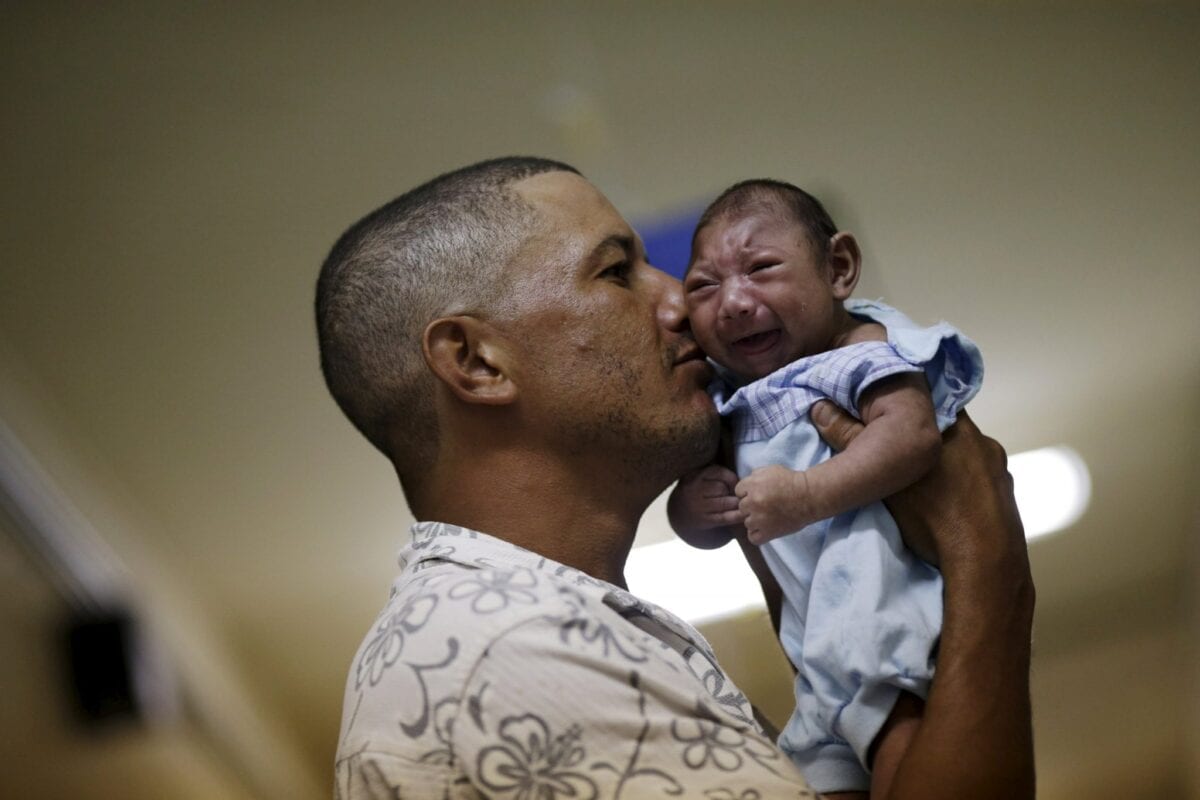 Geovane Silva holds his son Gustavo Henrique, who has microcephaly, at the Oswaldo Cruz Hospital in Recife, Brazil, January 26, 2016. Health authorities in the Brazilian state at the center of a rapidly spreading Zika outbreak have been overwhelmed by the alarming surge in cases of babies born with microcephaly, a neurological disorder associated to the mosquito-borne virus. Picture taken on January 26, 2016. REUTERS/Ueslei Marcelino TPX IMAGES OF THE DAY
