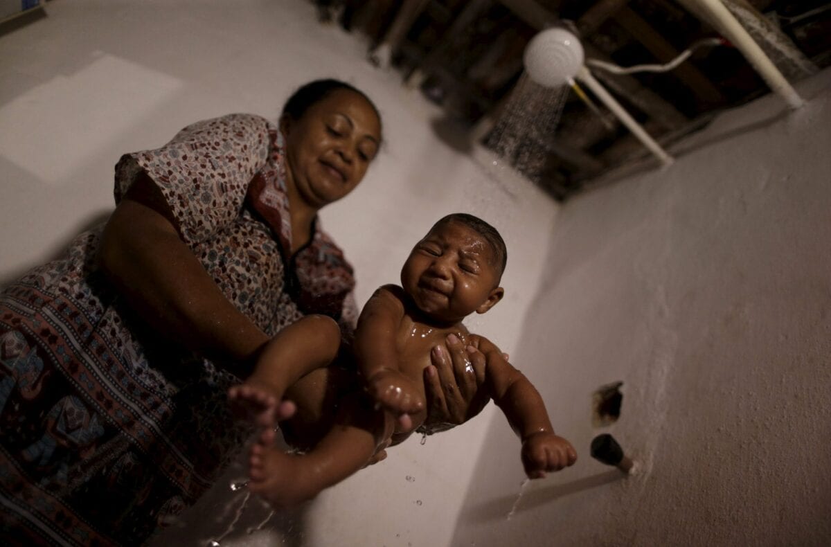 Hilda Venancio bathes her son Matheus, who has microcephaly, in Recife, Brazil, January 27, 2016. Health authorities in the Brazilian state at the center of a rapidly spreading Zika outbreak have been overwhelmed by the alarming surge in cases of babies born with microcephaly, a neurological disorder associated to the mosquito-borne virus. REUTERS/Ueslei Marcelino
